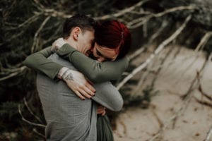 Couple hugging in the woods